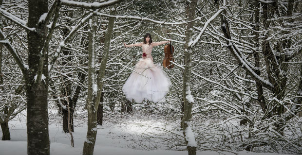 Floating bride in snowy forest by Halo and Hobby