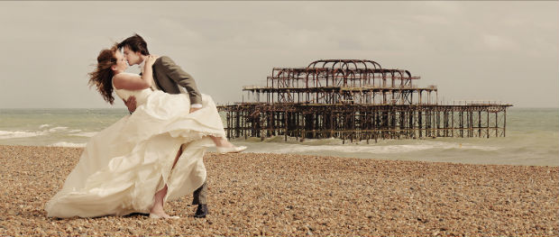 Romantic Brighton beach wedding kiss by Halo and Hobby