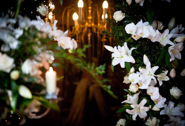 White indoor flower arrangement with candles