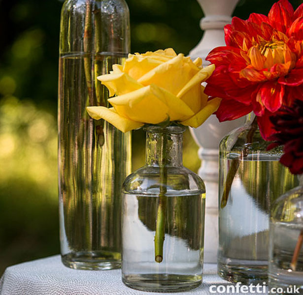 Glass vases for your wedding reception tables by Confetti