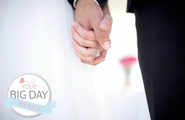 Bride and Groom holding hands wearing wedding rings