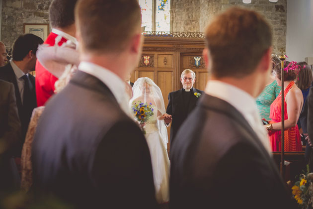 The bride walking down the aisle with her father 