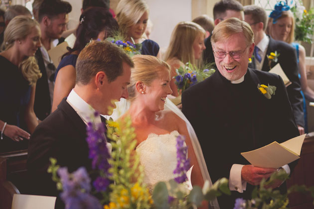 The bride and the groom together at the alter