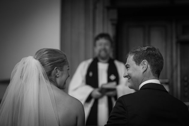 The bride and the groom together at the alter