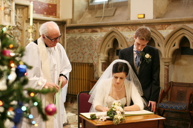 The newlyweds signing the register