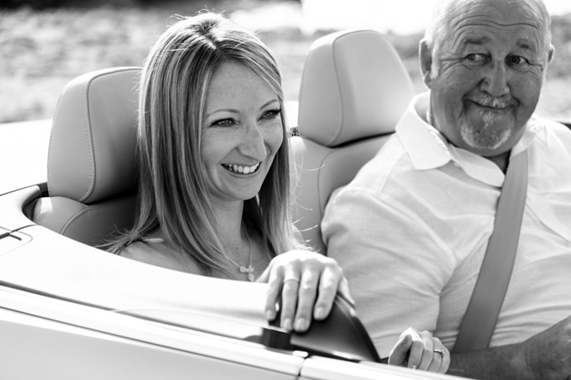 Bride in the wedding car with her father 