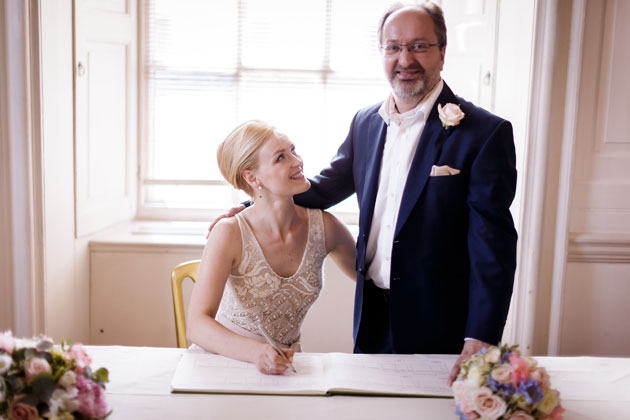 The newlyweds signing the register