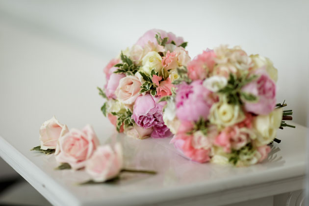 Pink and ivory wedding bouquets and pink rose button holes 