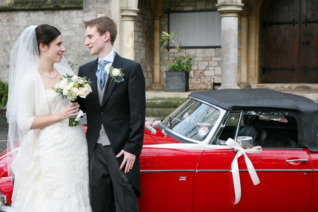 The happy couple with their red vintage MG