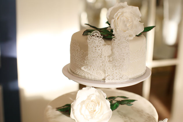 White lace wedding cake with white roses