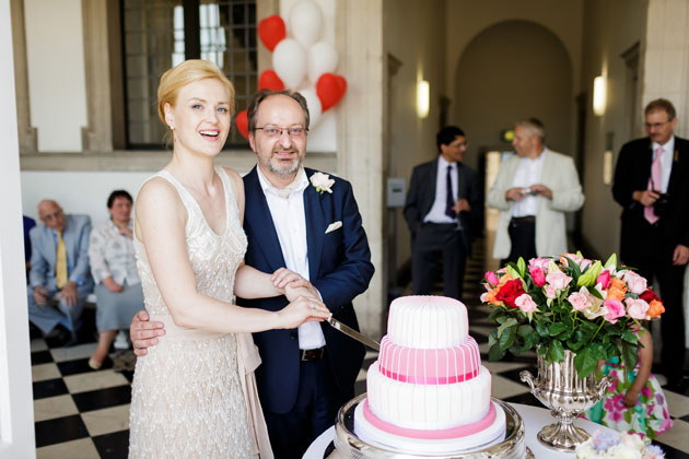 The happy couple cutting their wedding cake 