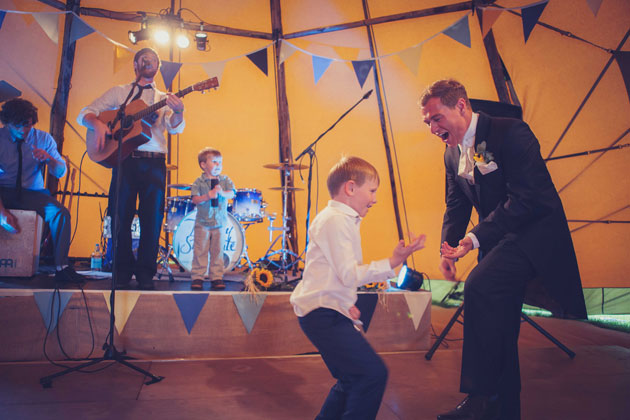 The groom and page boy enjoying the live music 