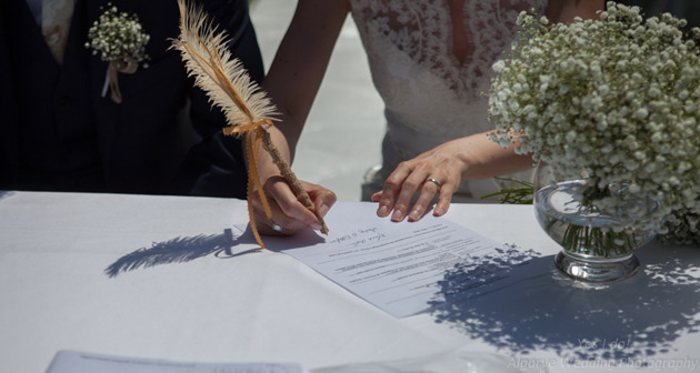 Signing the register with a feather pen  