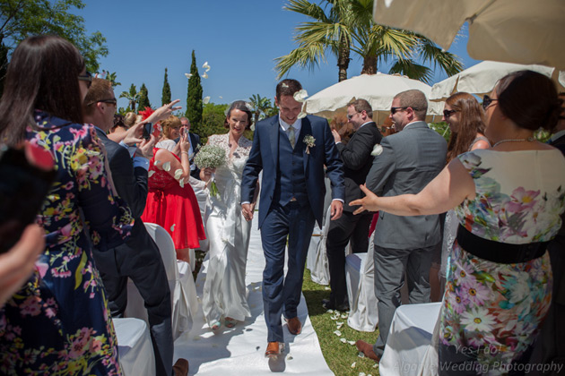 Guests throwing confetti over the newlyweds   