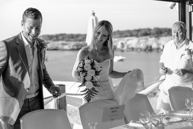 The bride and groom taking their seats at the top table 