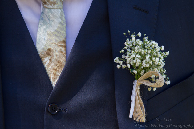 Baby breaths button hole for the groom        