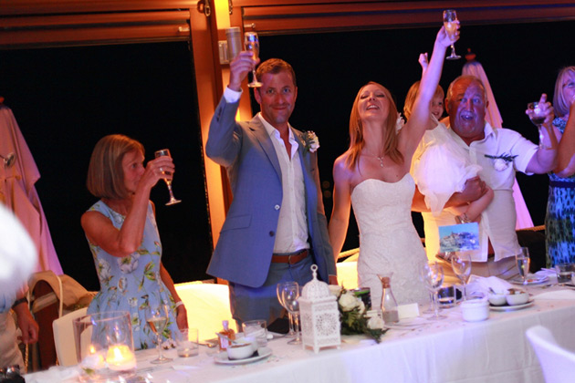 The wedding guests and the newlyweds toasting their marriage 