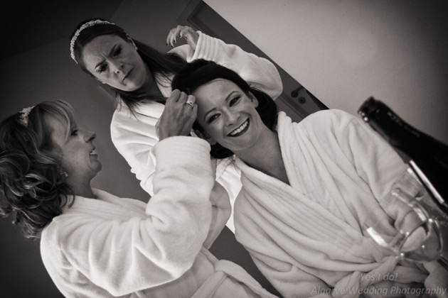 Bridesmaids helping the bride get ready