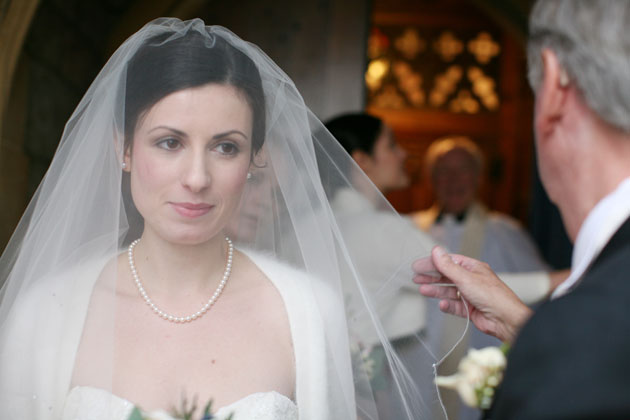 Bride adjusting her veil before the ceremony      