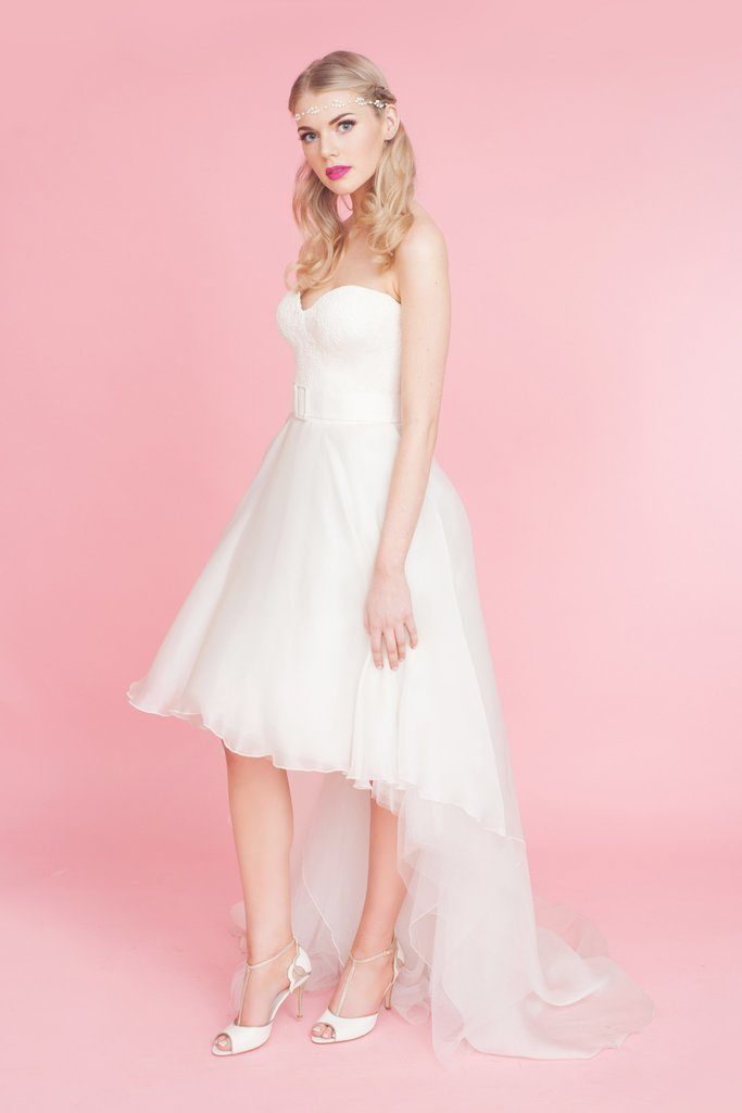 model posing in her wedding gown with Charlotte Mills ivory peep toes t-bar shoes with midi heel