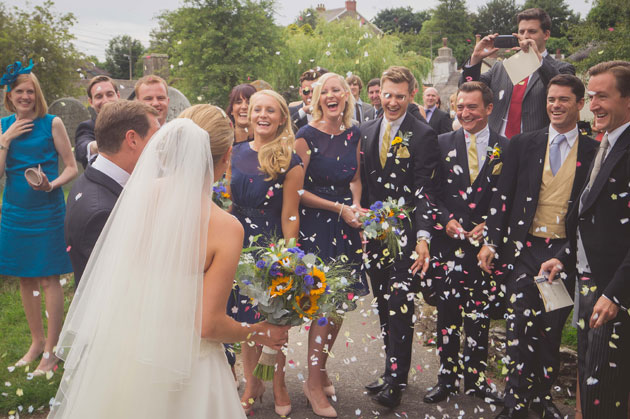 Wedding guests throwing confetti 