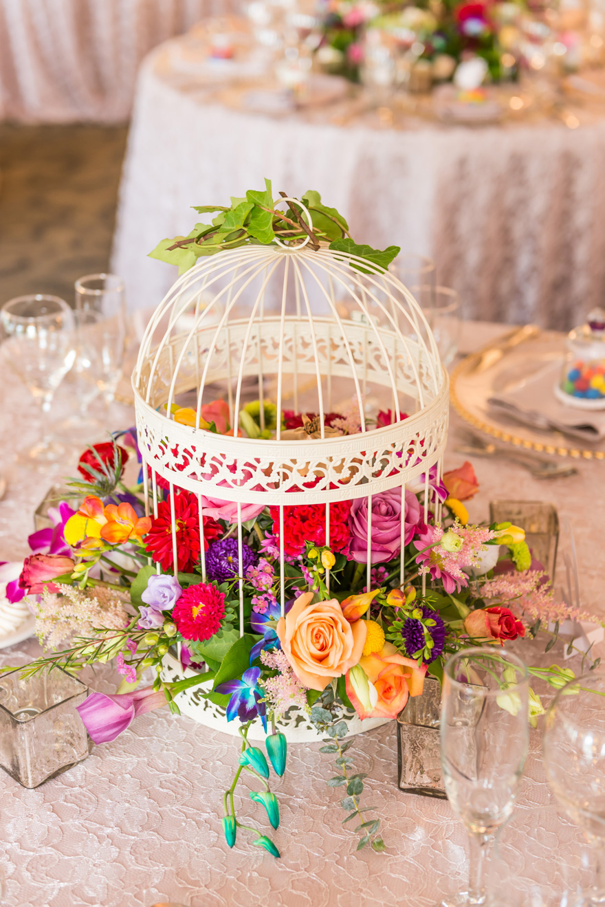 Summer Wedding Centrepiece Ideas Colourful Flowers in a Birdcage | Confetti.co.uk