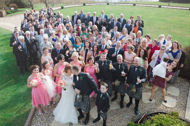 Group shot of the newlyweds with their guests   