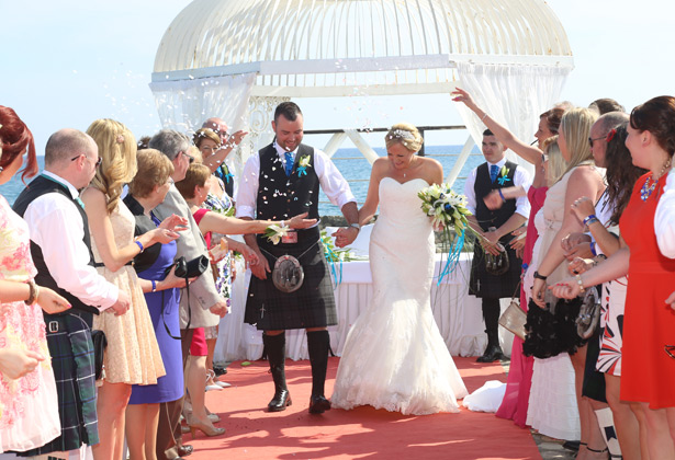 Guests throwing confetti over the happy couple