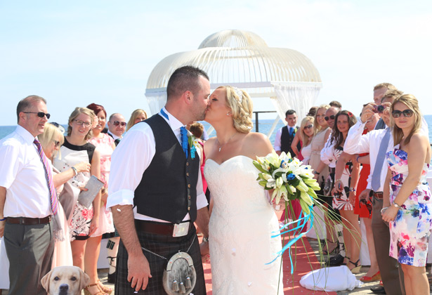 The newlyweds kissing