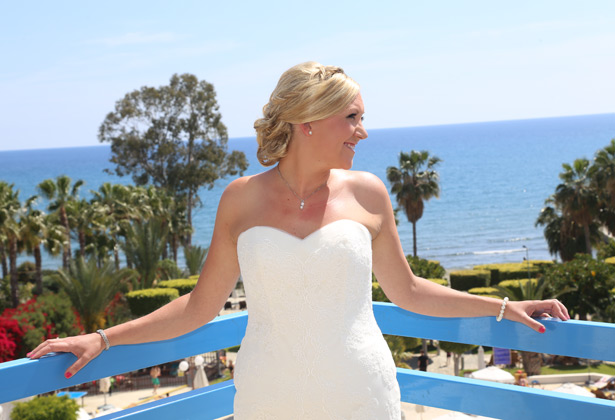 Bride in her strapless white wedding dress by La Sposa 