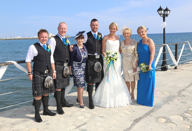 The happy couple with their family on the pier