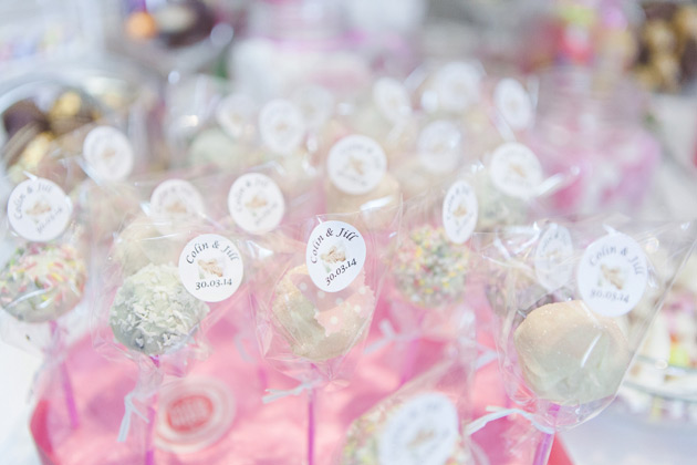 Pink and white wedding cake pops with personalised stickers 