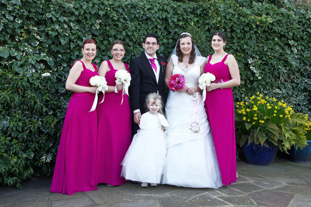 The newlyweds with their bridesmaids and the flower girl 