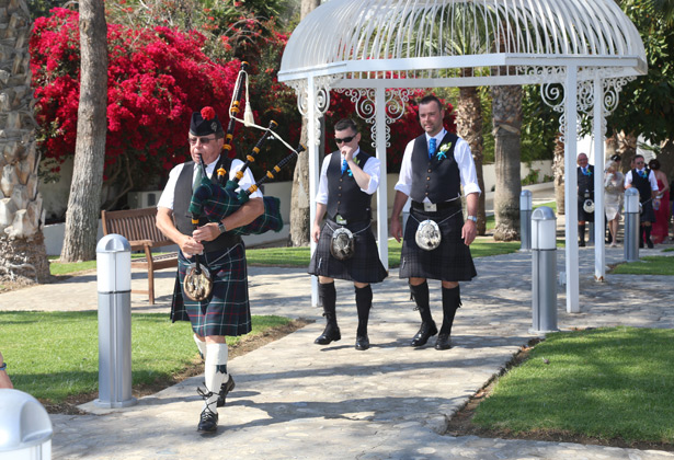 Traditional piper leading the way to the ceremony 