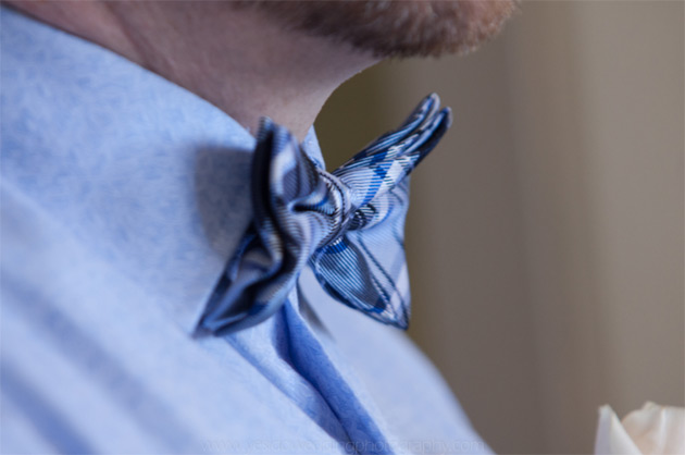 Groom’s blue shirt and blue checked bow tie 