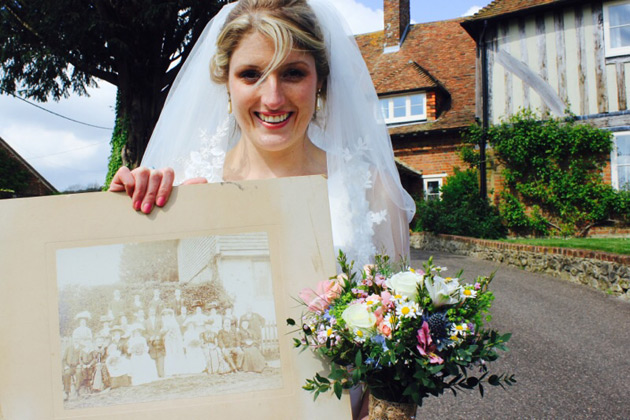 Bride holding up a vintage photo 