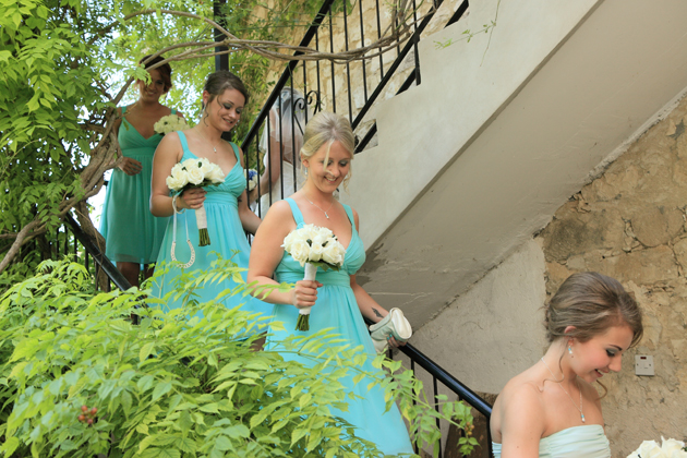 Bridesmaids walking down the stairs to the ceremony