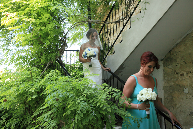 The bride walking down to the stairs to the ceremony