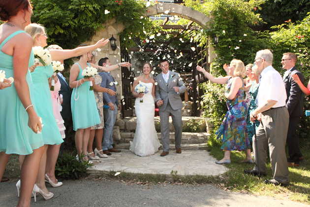 Guests throwing confetti over the newlyweds 