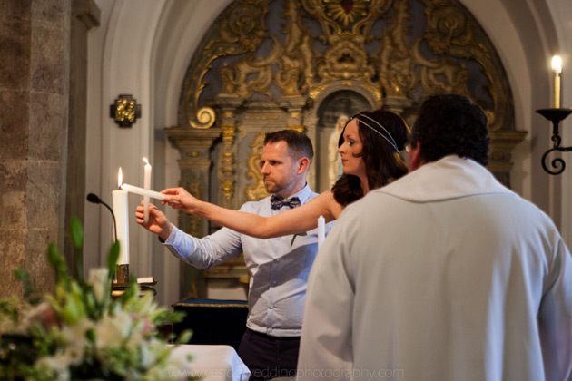 The bride and groom lighting candles during the ceremony 