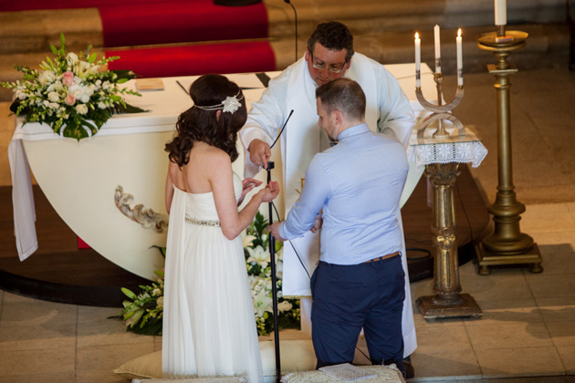 The bride and groom exchanging rings 