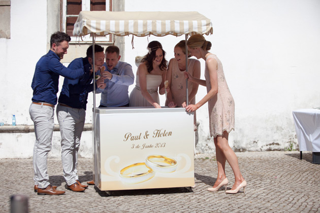 The bride and groom with their bridesmaids and groomsmen at a personalised ice cream cart