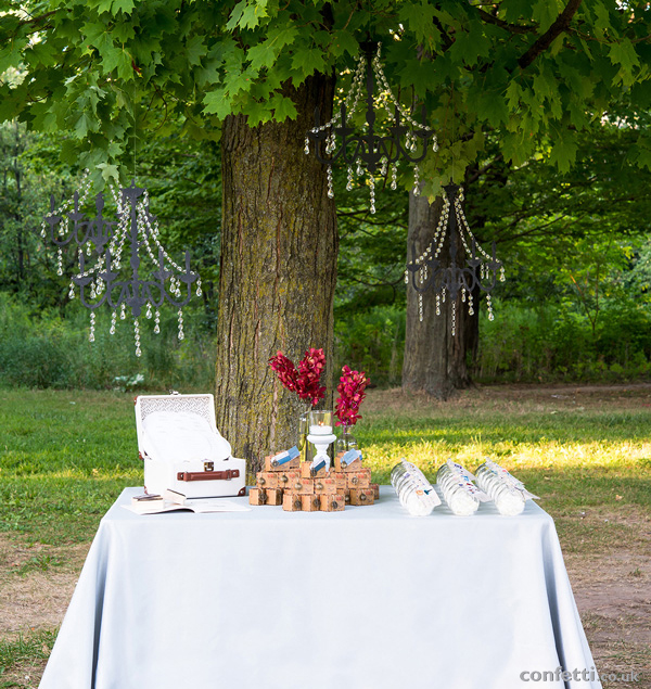 Wanderlust themed wedding table with black crystal chandeliers   