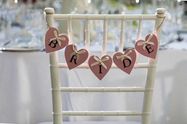 Heart shaped bride banner across the chair   