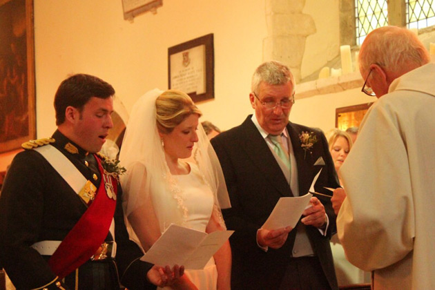 The bride and groom singing hymns during the ceremony  