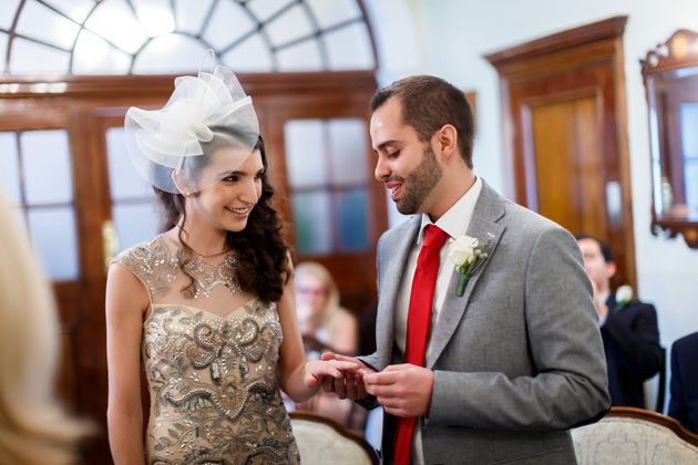 The groom placing the ring on the brides finger | Confetti.co.uk