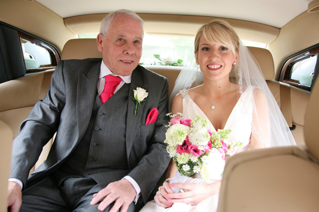 Bride with her father in the wedding car on their way to the wedding ceremony |Confetti.co.uk