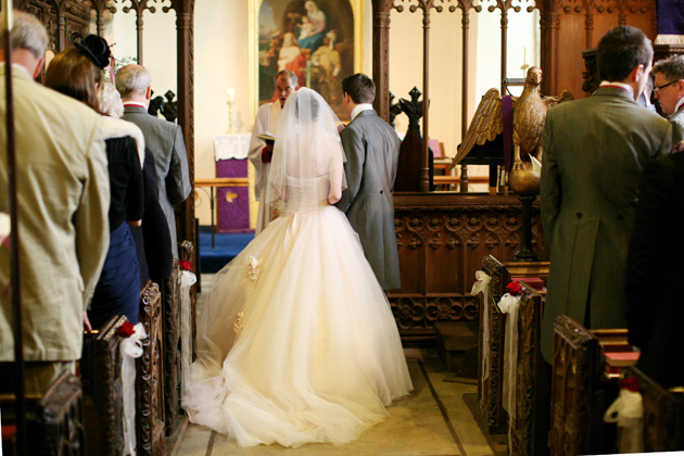 Bride and groom at the alter | Confetti.co.uk