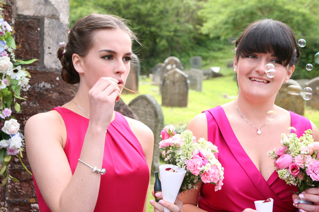 Bridesmaids blowing bubbles after the ceremony | Confetti.co.uk