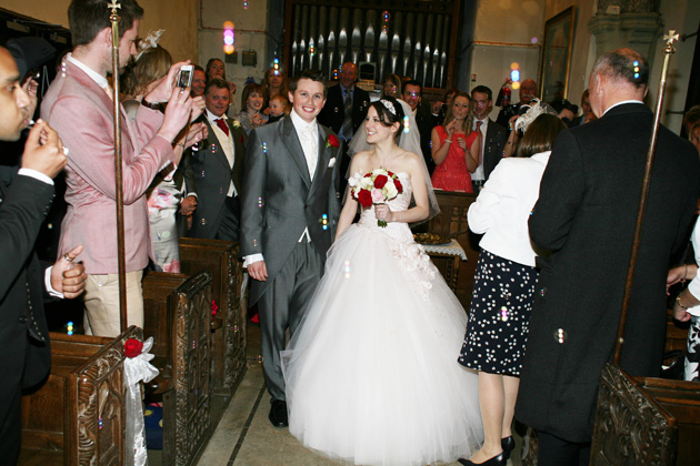 The newlyweds leaving the church | Confetti.co.uk